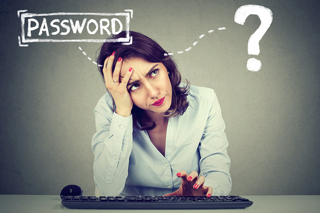 User with mouse and keyboard trying to think of password with floating password graphic and question mark