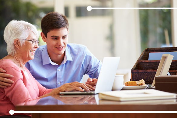 Man helps grandmother with laptop